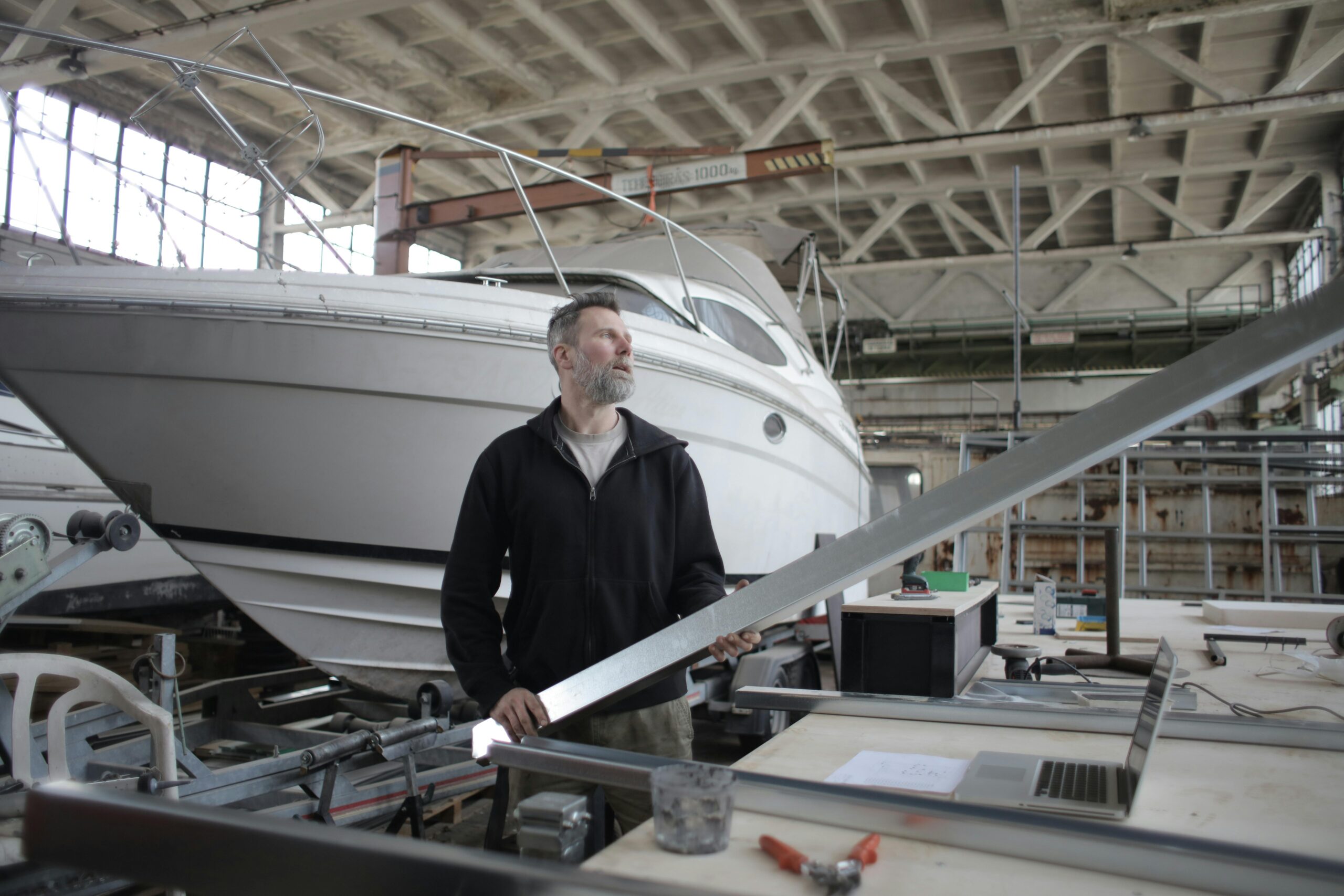 yacht repair- man repairing yacht
